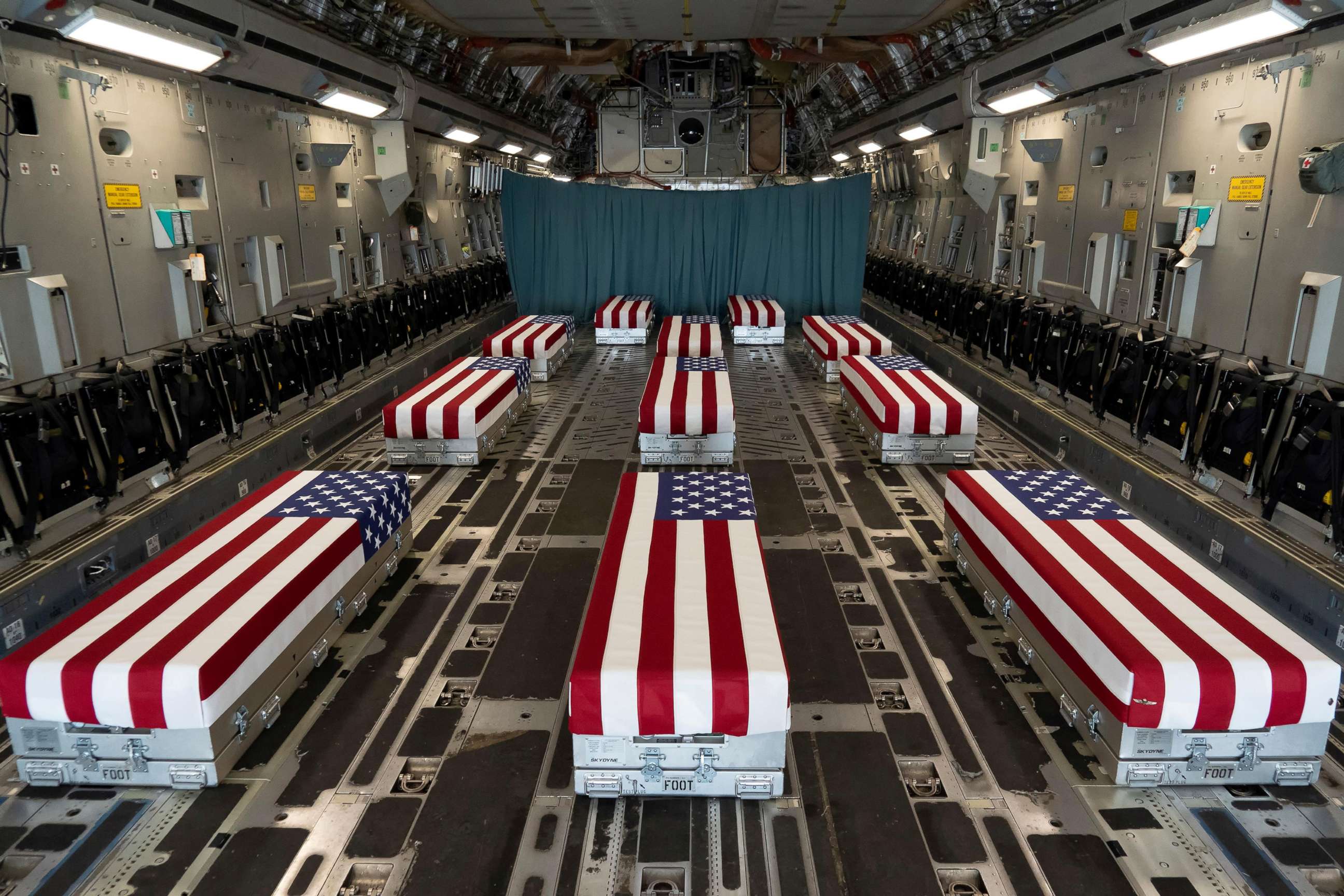 PHOTO: Flag-draped transfer cases of U.S. military service members who were killed by an August 26 suicide bombing at Kabul's Hamid Karzai International Airport prior to a dignified transfer at Dover Air Force Base, Del., Aug. 29, 2021.   