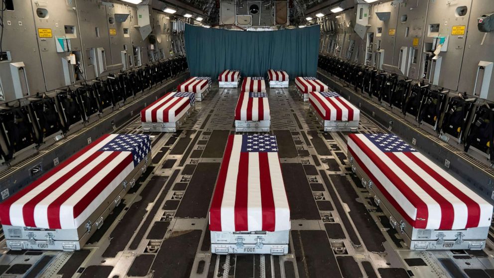PHOTO: Flag-draped transfer cases of U.S. military service members who were killed by an August 26 suicide bombing at Kabul's Hamid Karzai International Airport prior to a dignified transfer at Dover Air Force Base, Del., Aug. 29, 2021.   