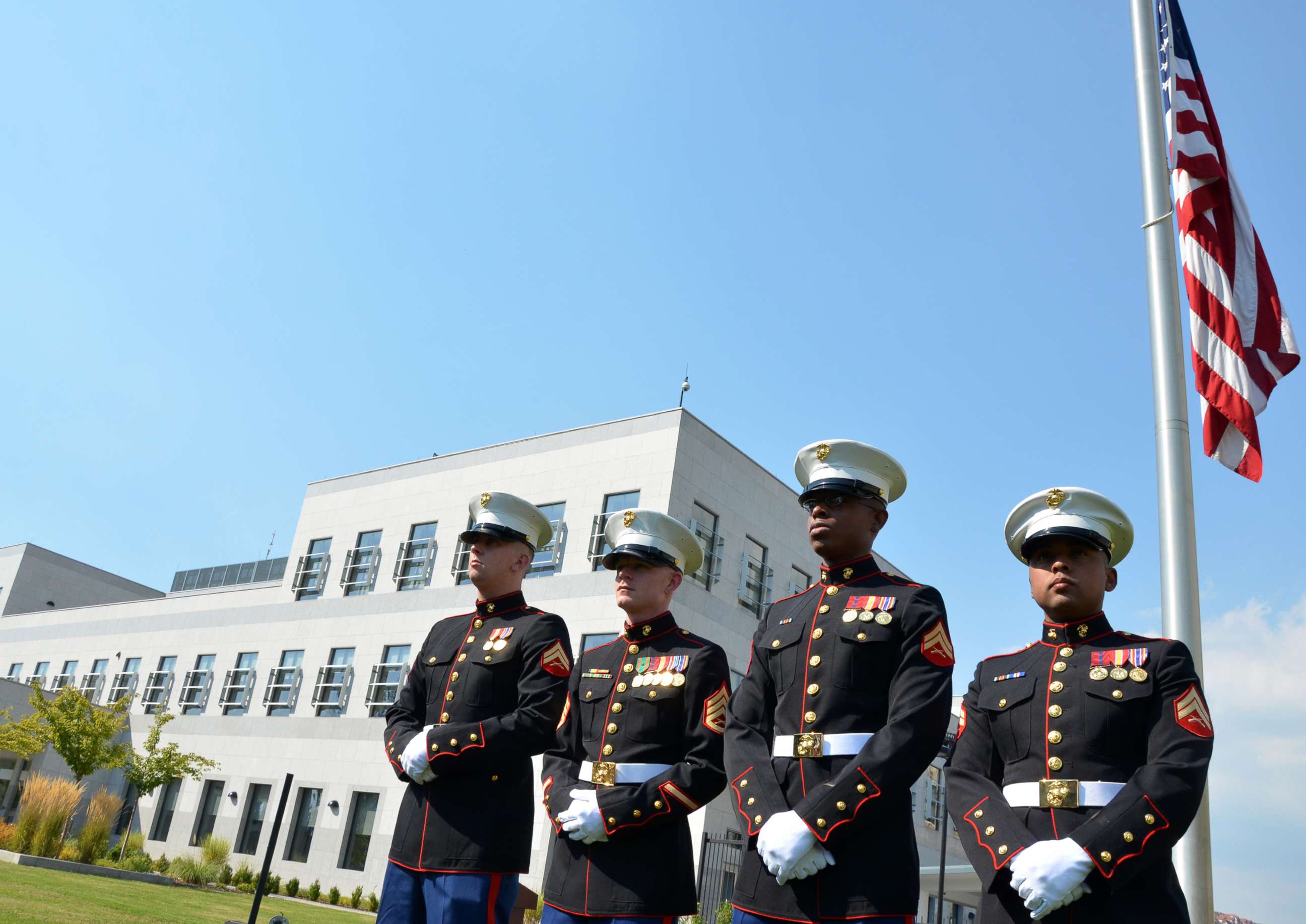 PHOTO: US Marines stand in front of the flag of the United States of America, in front of the US embassy in Sarajevo, Sept. 9, 2011.
