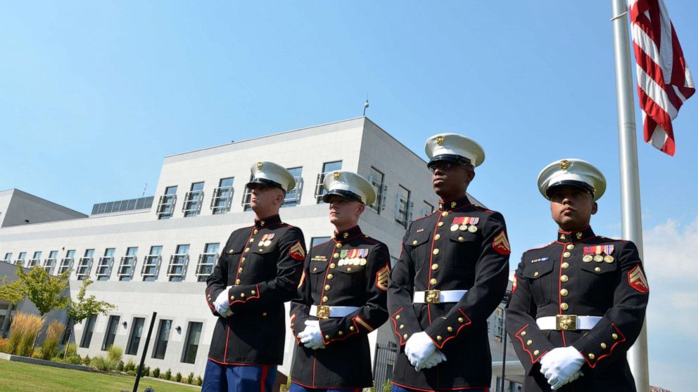 PHOTO: US Marines stand in front of the flag of the United States of America, in front of the US embassy in Sarajevo, Sept. 9, 2011.
