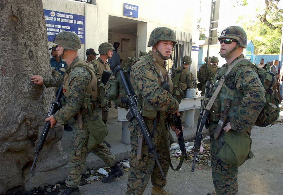 PHOTO: US Marines post guard in front of the Consular office of the US Embassy in Port-Au-Prince, Haiti, March 5, 2004.