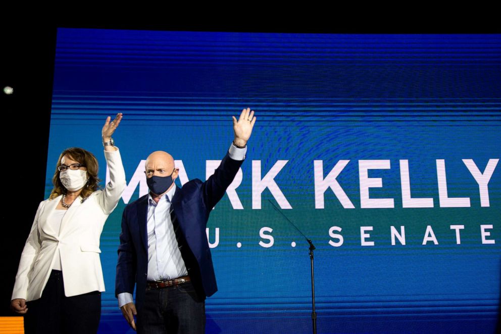 PHOTO: Democratic U.S. Senate candidate Mark Kelly and former Arizona congresswoman Gabrielle Giffords wave to supporters during the Election Night event at Hotel Congress on Nov. 3, 2020, in Tucson, Arizona.