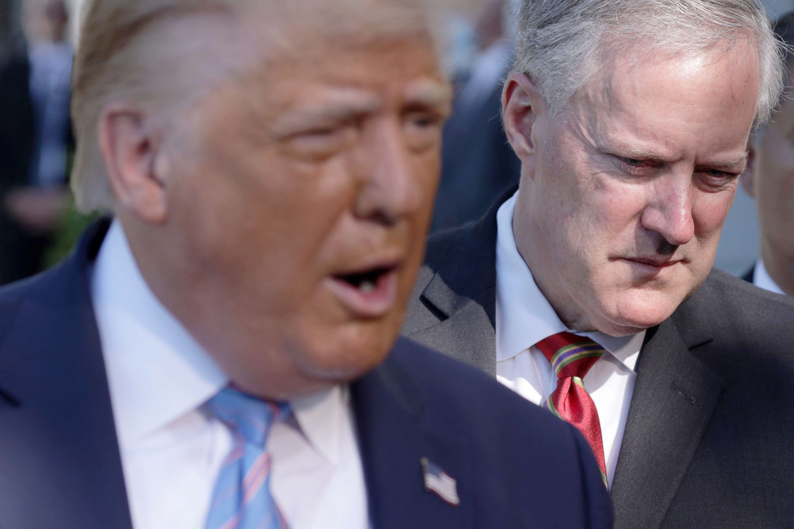 PHOTO: In this July 29, 2020 file photo President Donald Trump speaks as White House Chief of Staff Mark Meadows listens prior to departure from the South Lawn of the White House. 