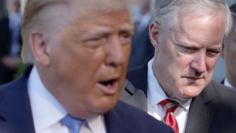 PHOTO: In this July 29, 2020 file photo President Donald Trump speaks as White House Chief of Staff Mark Meadows listens prior to departure from the South Lawn of the White House. 