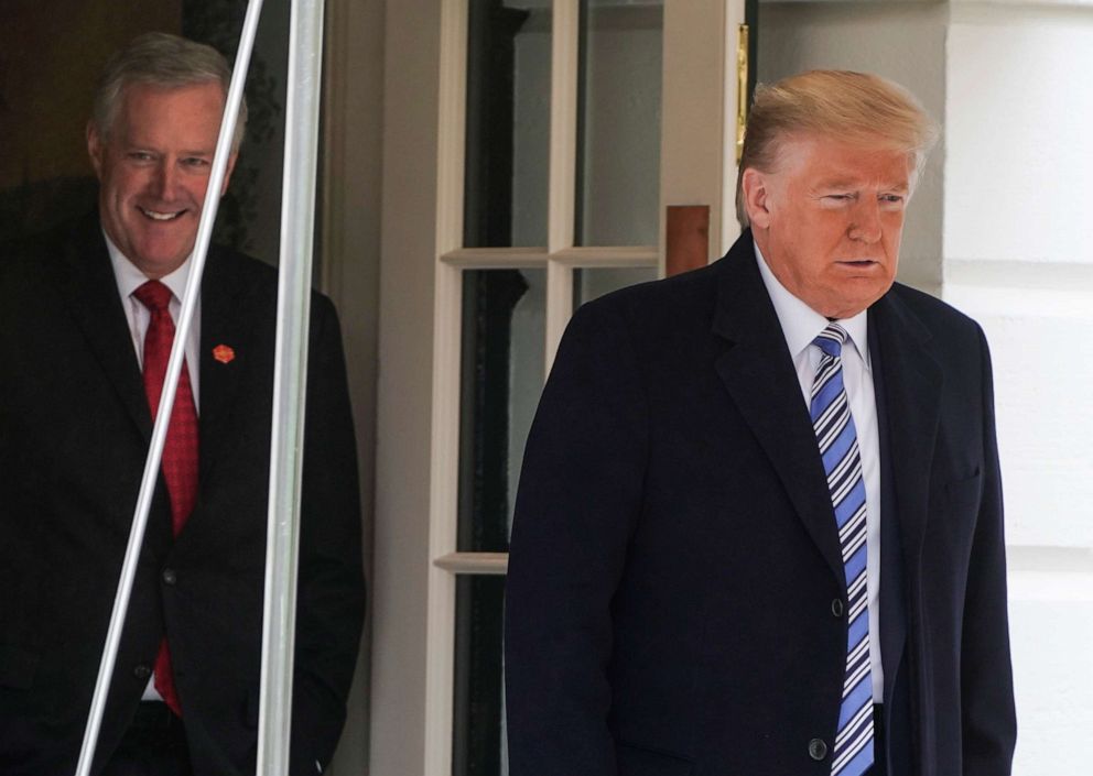 PHOTO: President Donald Trump is followed by White House Chief of Staff Mark Meadows as he departs for a day trip to Norfolk, Va., from the White House in Washington, March 28, 2020. 