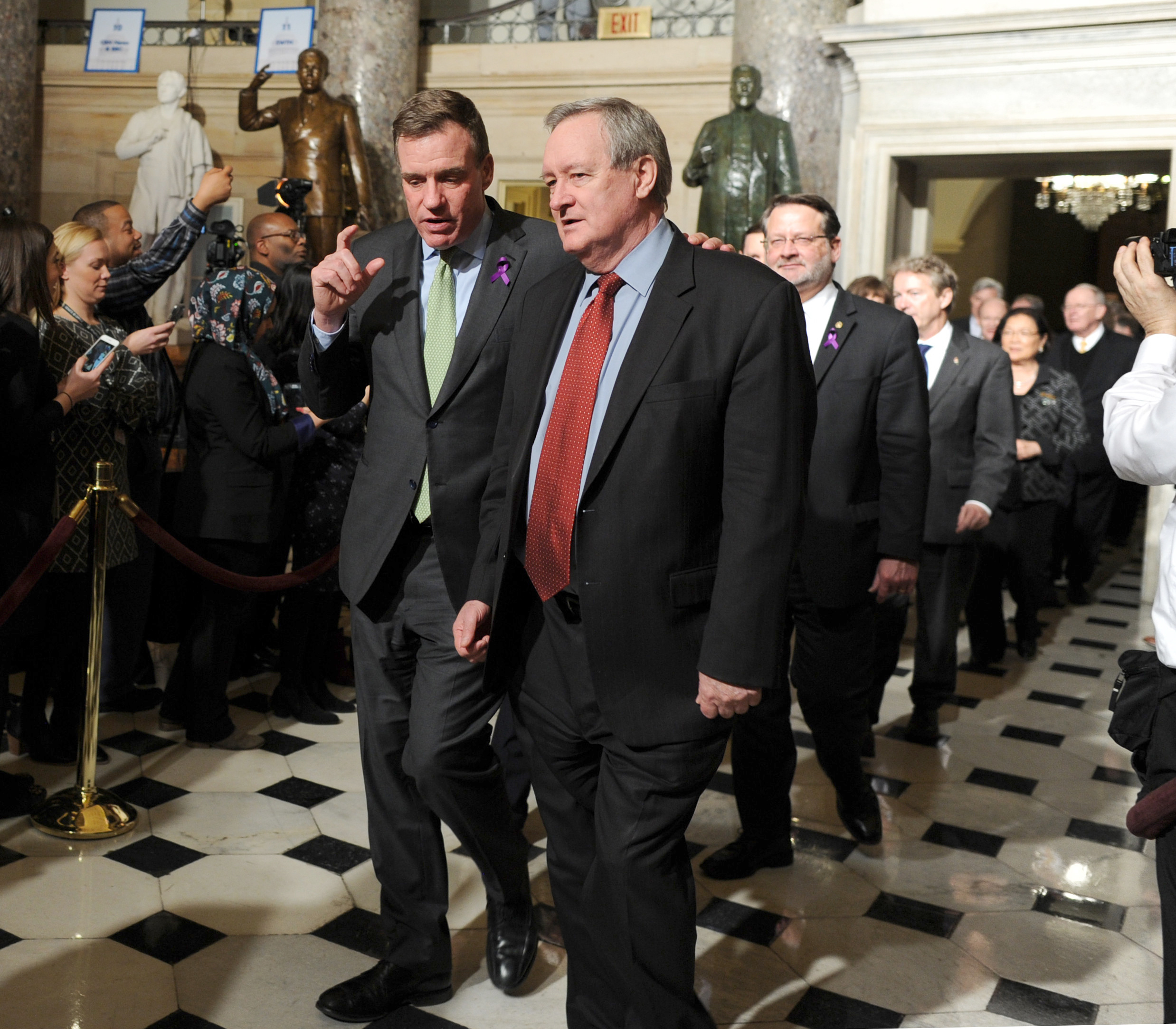 PHOTO: Senators Mark Warner (D-VA) left,, and Mike Crapo (R-ID) walk through Statuary Hall on Capitol Hill to attend President Trump's State of the Union address, Jan. 30, 2018.