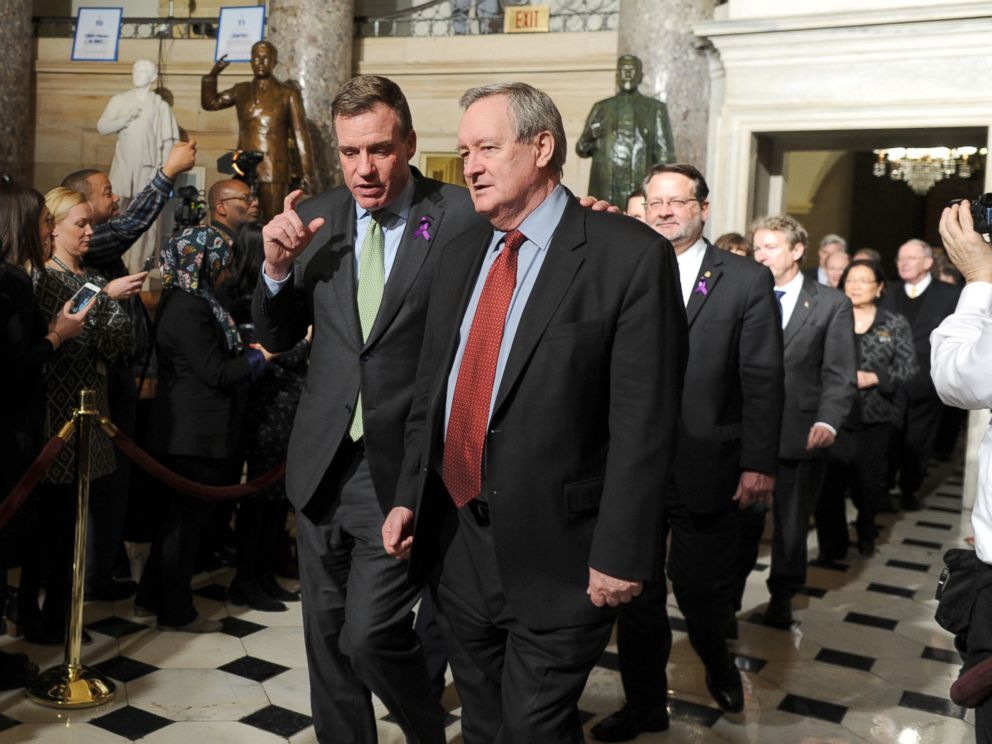 PHOTO: Senators Mark Warner (D-VA) left,, and Mike Crapo (R-ID) walk through Statuary Hall on Capitol Hill to attend President Trumps State of the Union address, Jan. 30, 2018.