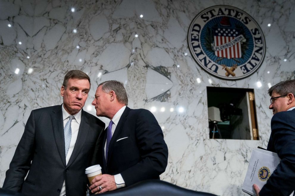 PHOTO: Vice Chairman Mark Warner, D-Va., left, and Chairman Richard Burr, R-N.C., second from left, speak together following a Senate Select Committee on Intelligence hearing on worldwide threats, Feb. 13, 2018, in Washington.