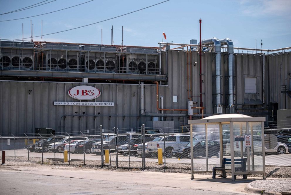 PHOTO: Cars sit parked outside JBS Swift and Co., a pork meat packing plant in Marshalltown, Iowa, Aug. 7, 2019. The plant's workforce has shifted over the years from mostly white workers to a lot of immigrant and more recently, refugee workers.
