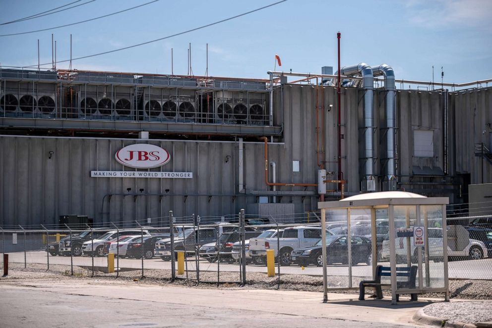 PHOTO: Cars sit parked outside JBS Swift and Co., a pork meat packing plant in Marshalltown, Iowa, Aug. 7, 2019. The plants workforce has shifted over the years from mostly white workers to a lot of immigrant and more recently, refugee workers.