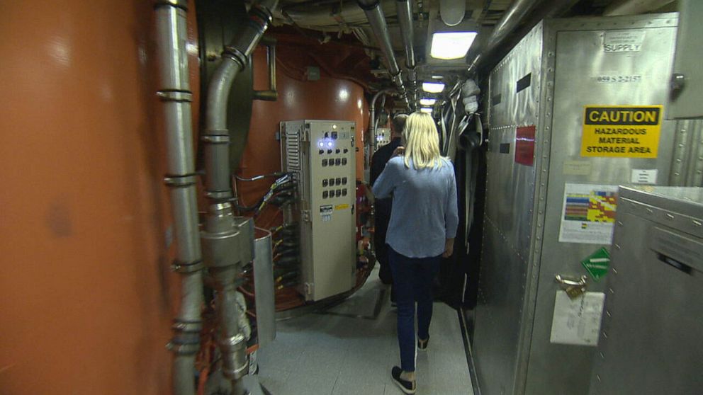 PHOTO: Martha Raddatz walks past four story tall missile tubes that contain Trident II missiles.