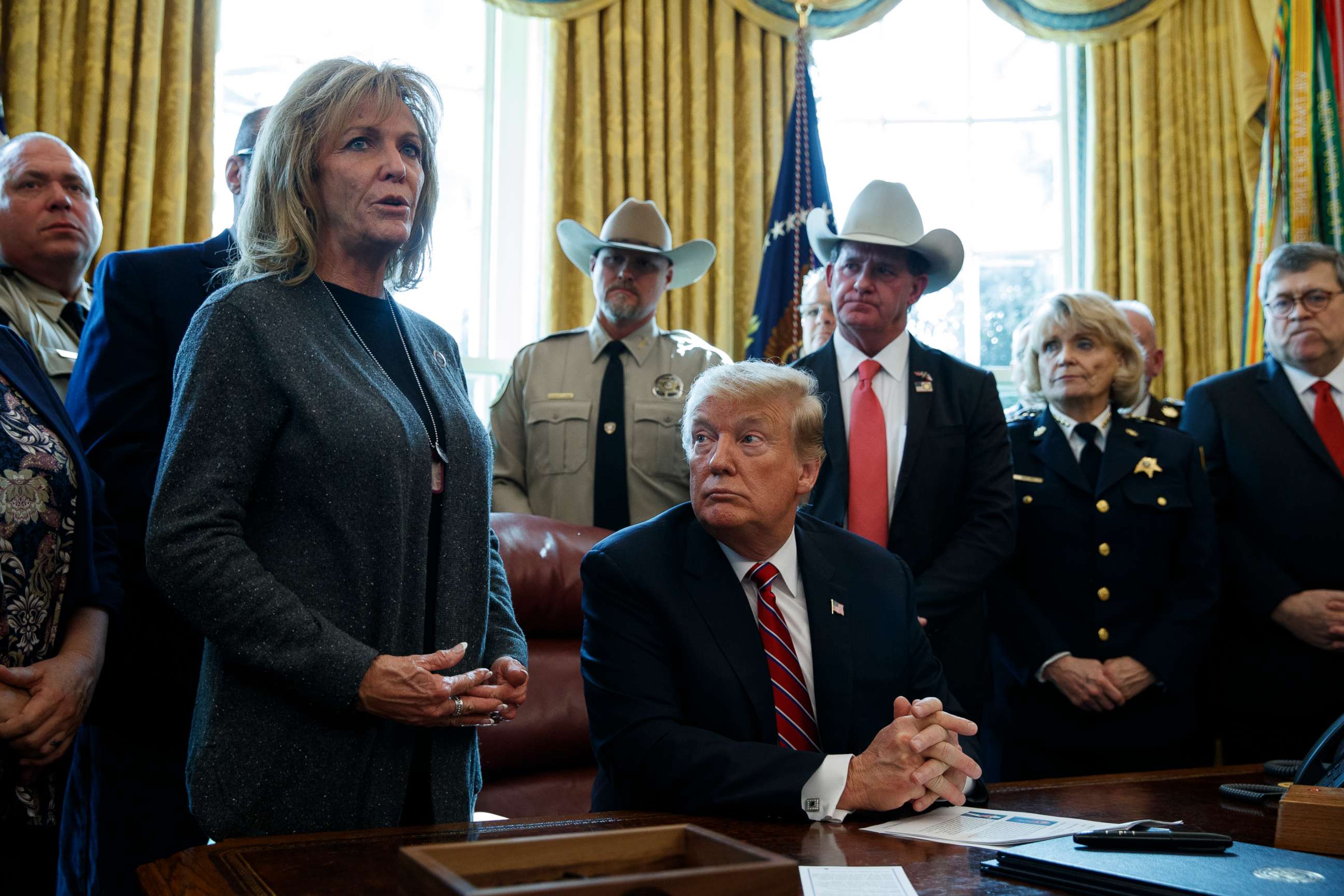 PHOTO: President Donald Trump listens as Mary Ann Mendoza, an "Angel Mom" who lost her son Brandon when he was killed by a drunk driver that was an undocumented immigrant, speaks in the Oval Office of the White House, March 15, 2019, in Washington.