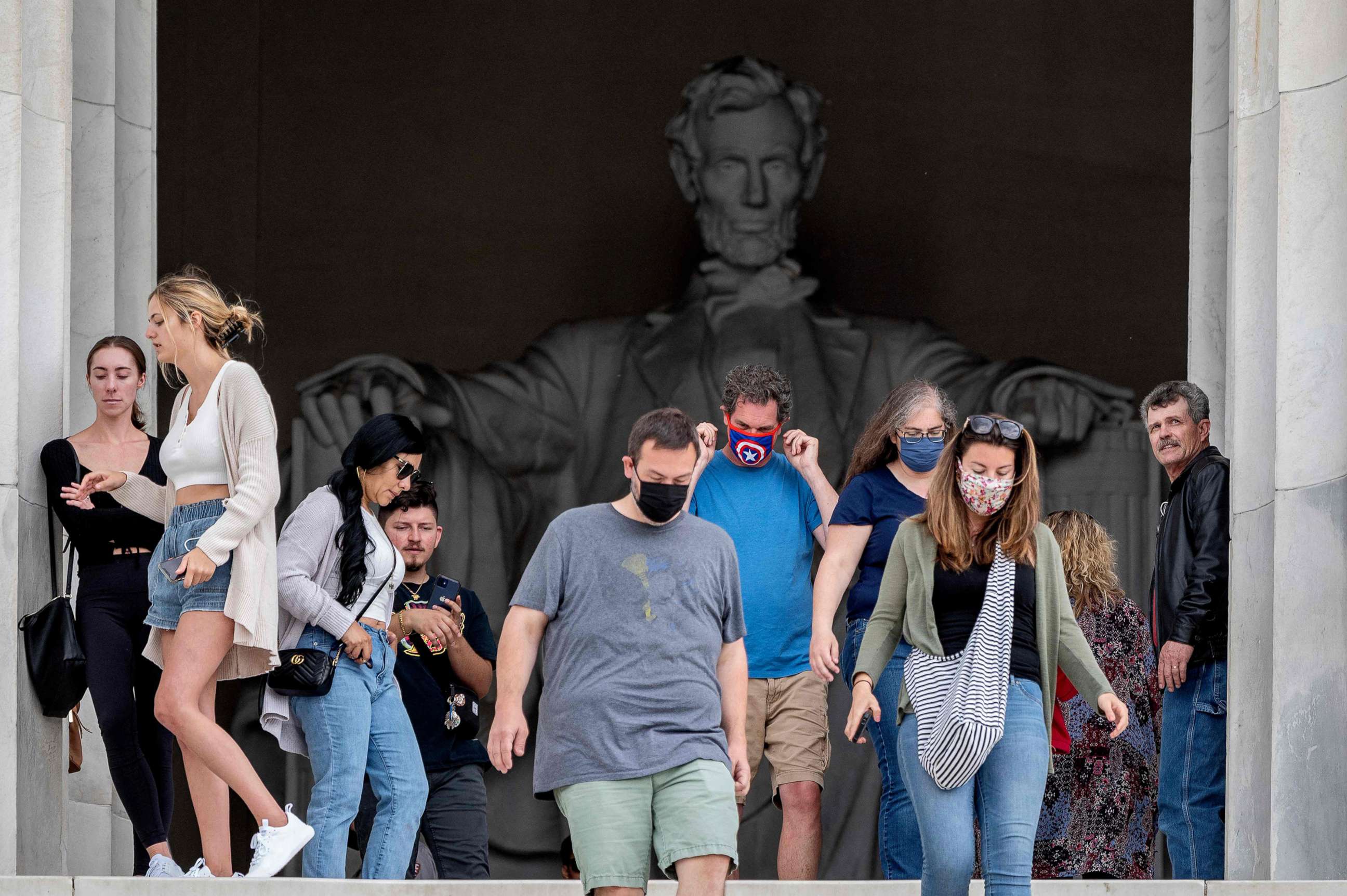 PHOTO: Tourists, some in face masks while others are not, visit the Lincoln Memorial in Washington, D.C., May 14, 2021. 