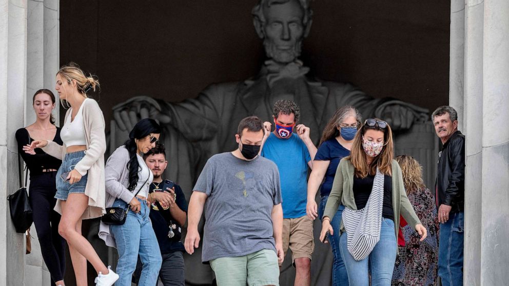PHOTO: Tourists, some in face masks while others are not, visit the Lincoln Memorial in Washington, D.C., May 14, 2021. 