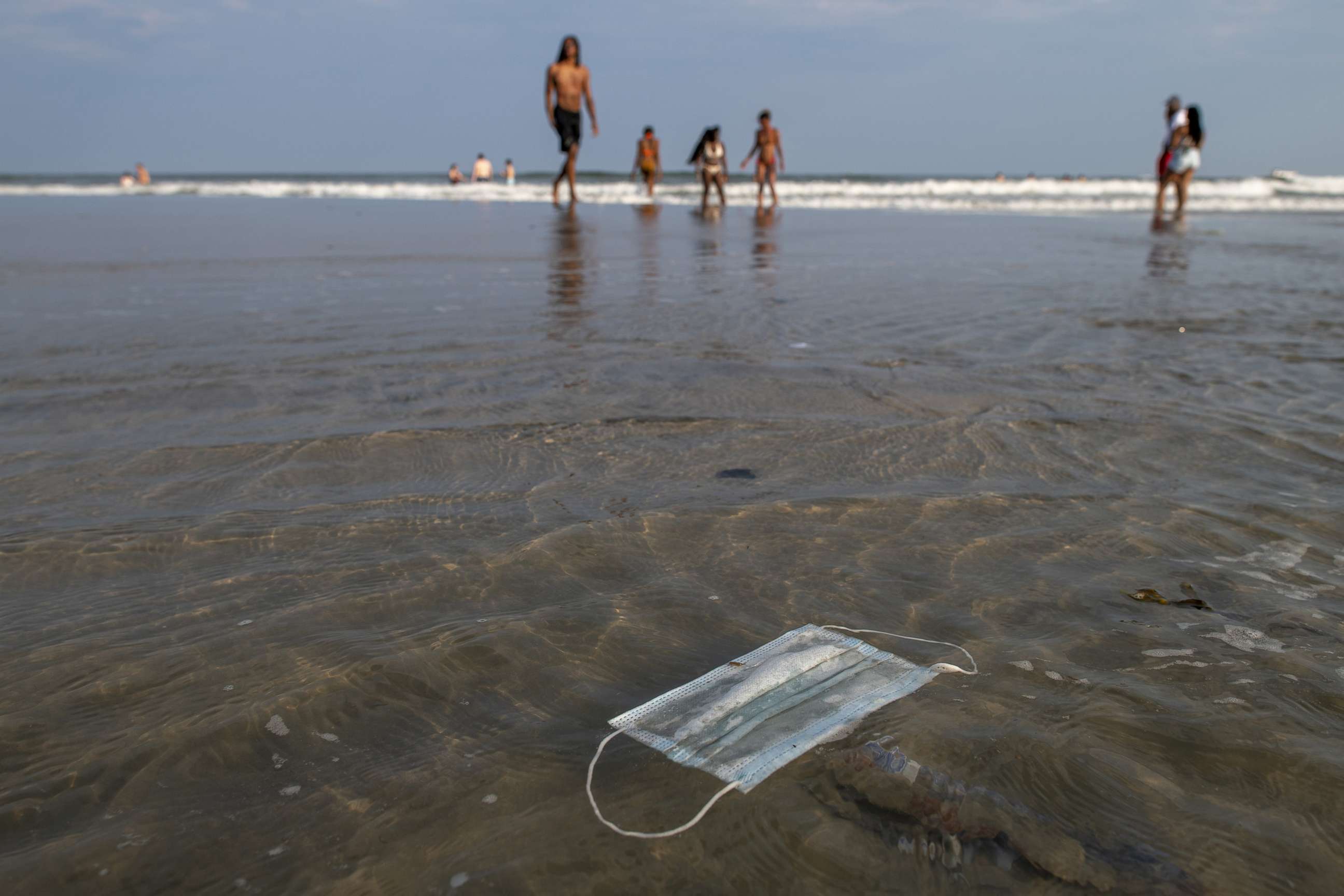 PHOTO: A discarded mask floats in the ocean surf, July 3, 2020, in Wildwood, N.J.