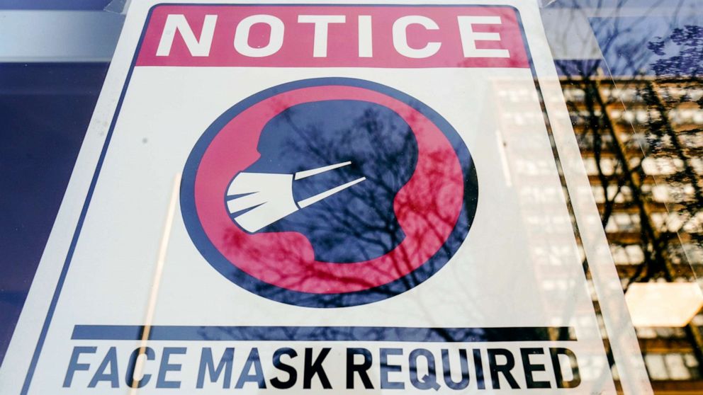 PHOTO: A sign requiring masks as a precaution against the spread of the coronavirus is posted on a store front in Philadelphia, Feb. 16, 2022.