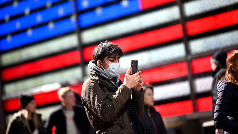 PHOTO: A man wears a mask as uses his cellphone in Times Square on March 5, 2020, in New York City.