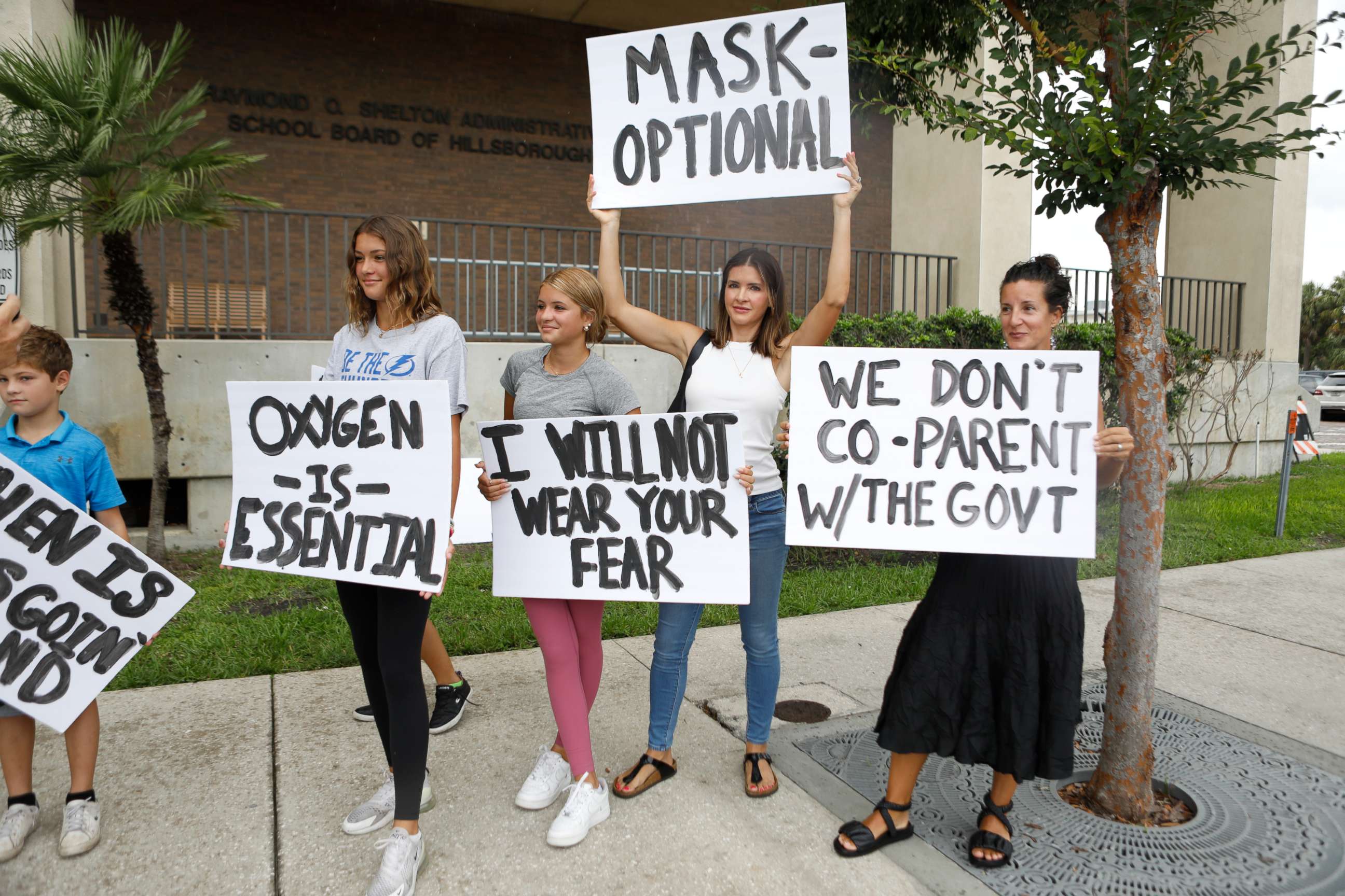 PHOTO: Families protest any potential mask mandates before the Hillsborough County Schools Board meeting held at the district office on July 27, 2021 in Tampa, Florida. 