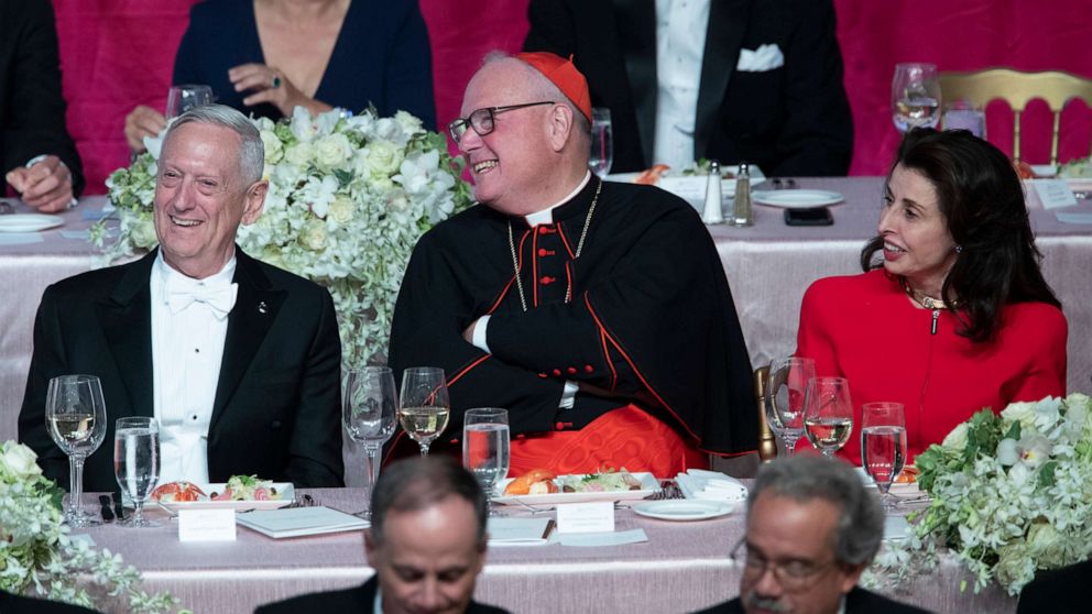 PHOTO: Former U.S. Secretary of Defense Jim Mattis, left, Cardinal Timothy Dolan, center, and Happy Warrior Award Recipient Mary Ann Tighe react to opening remarks during the 74th Annual Alfred E. Smith Dinner, Thursday, Oct. 17, 2019, in New York.