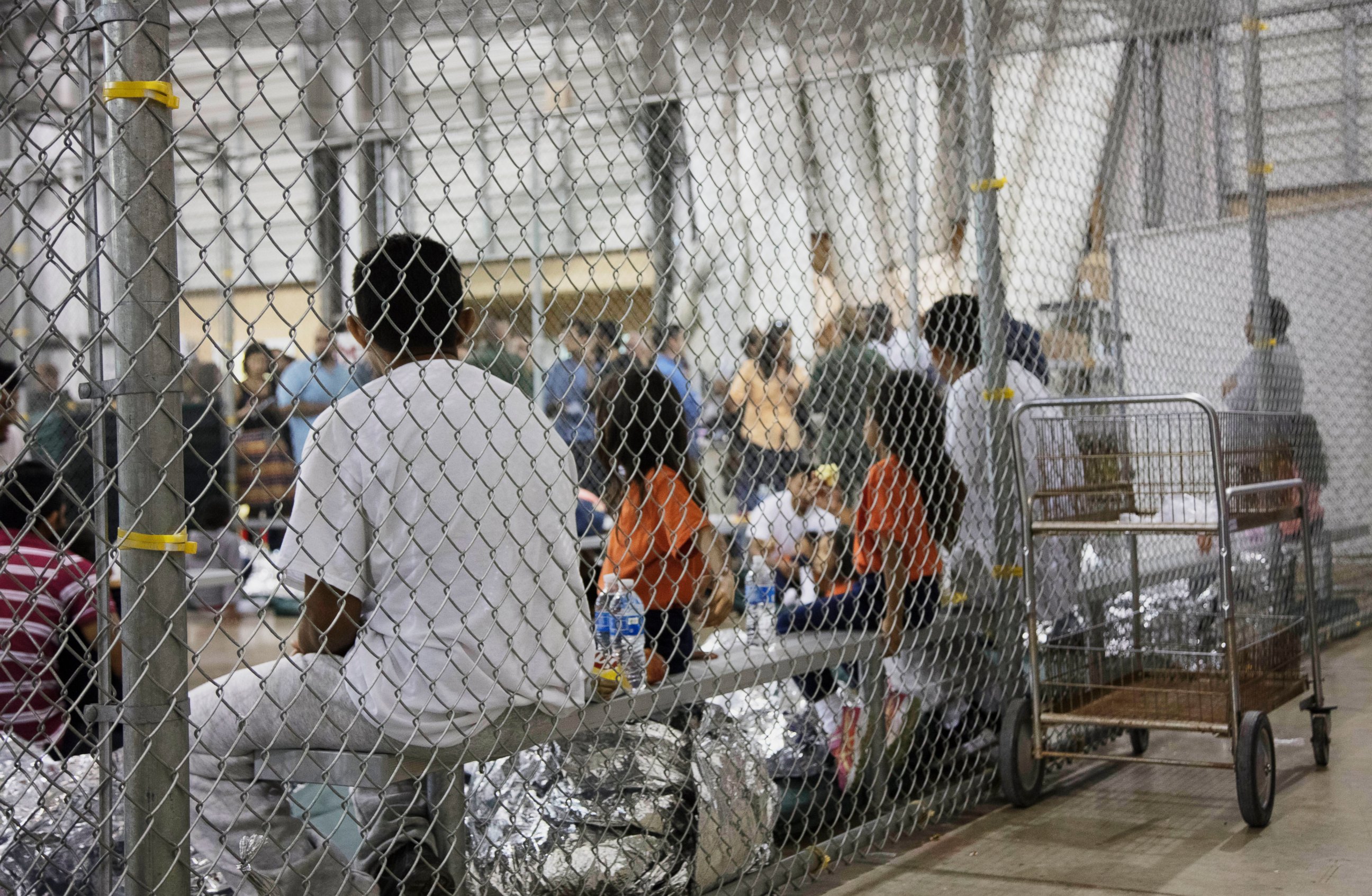PHOTO: In this June 17, 2018, file photo, provided by U.S. Customs and Border Protection, people who have been taken into custody related to cases of illegal entry into the United States, sit in one of the cages at a facility in McAllen, Texas.