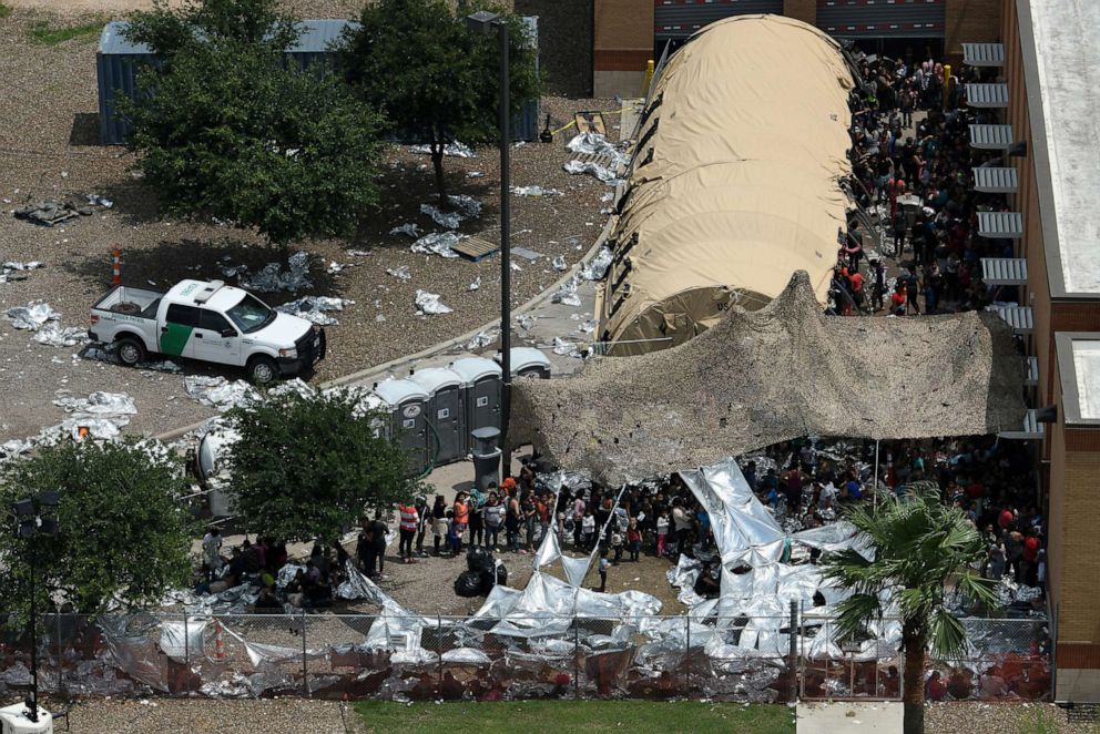 PHOTO: At a nearby facility to the Central Processing Center where a suspected flu outbreak has prompted officials to stop processing, migrants look out from a makeshift encampment at the U.S. Border Patrol McAllen Station in McAllen, Texas, May 15, 2019.