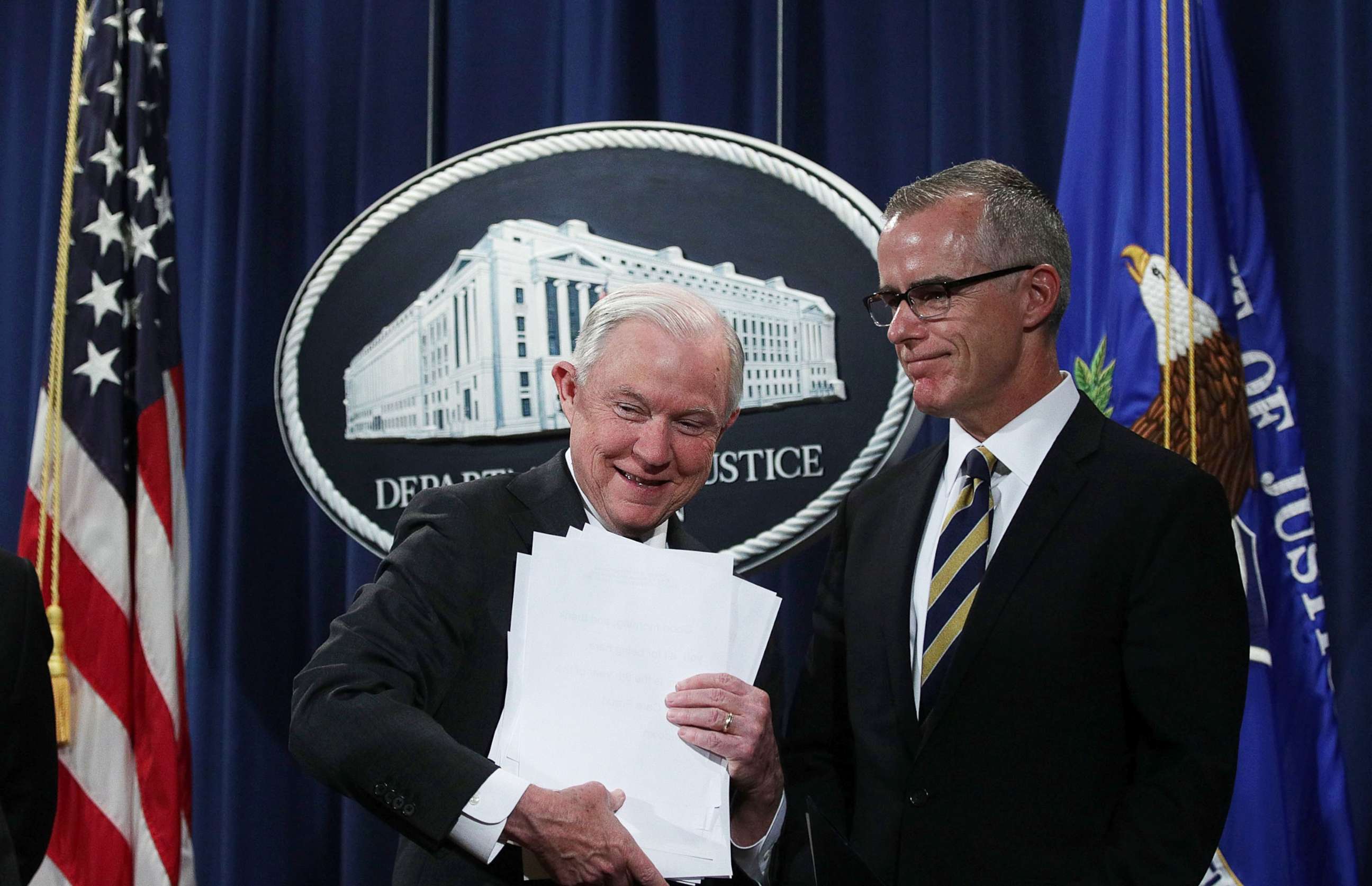 PHOTO: U.S. Attorney General Jeff Sessions picks up his remarks as Acting FBI Director Andrew McCabe looks on during a news conference at the Justice Department in Washington, July 13, 2017.