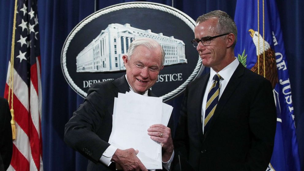 U.S. Attorney General Jeff Sessions picks up his remarks as Acting FBI Director Andrew McCabe looks on during a news conference at the Justice Department in Washington, July 13, 2017.