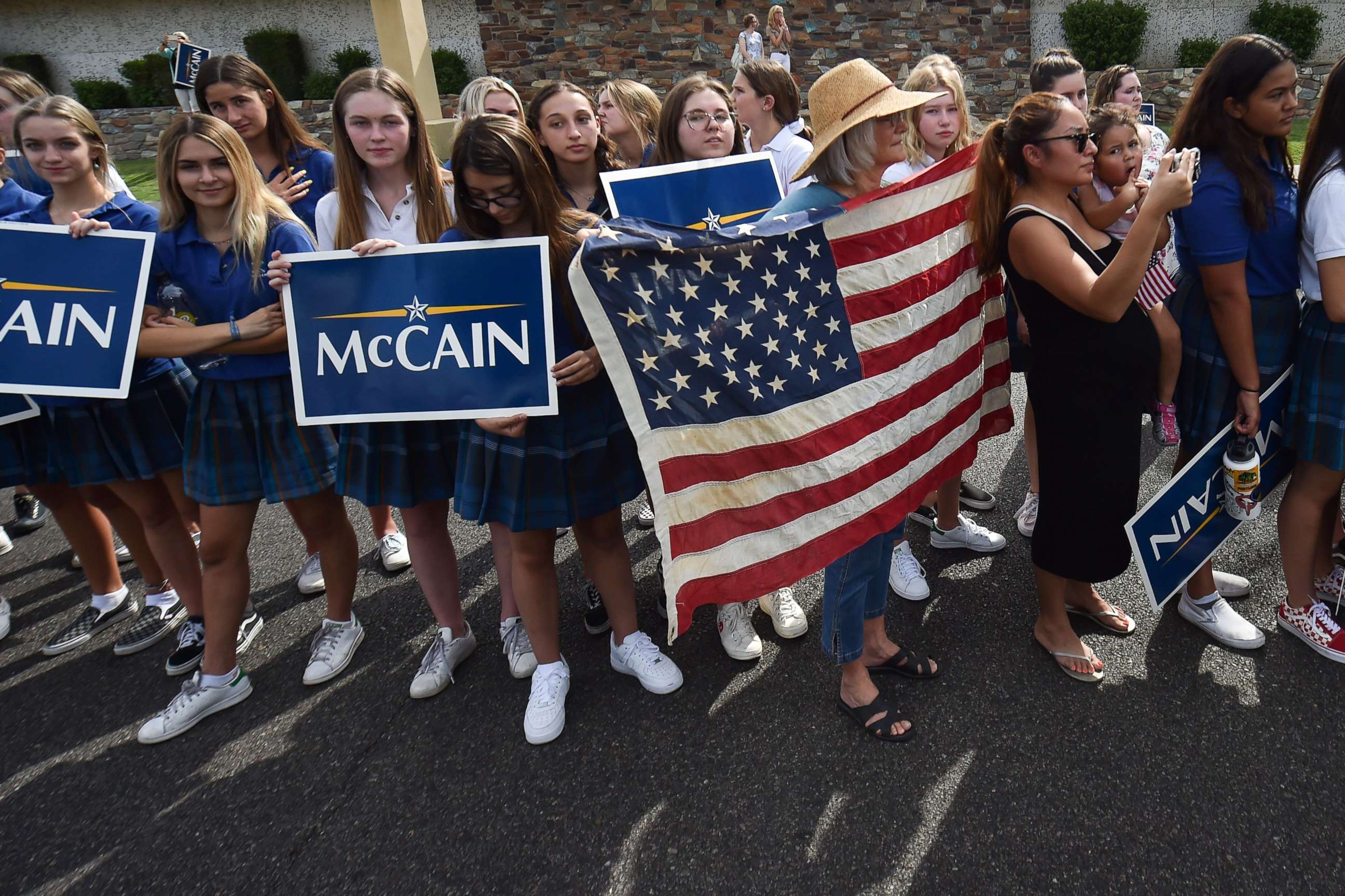 PHOTO: People gather along the street after the memorial service for the late Senator John McCain at the North Phoenix Baptist Church, Aug. 30, 2018, in Phoenix. 