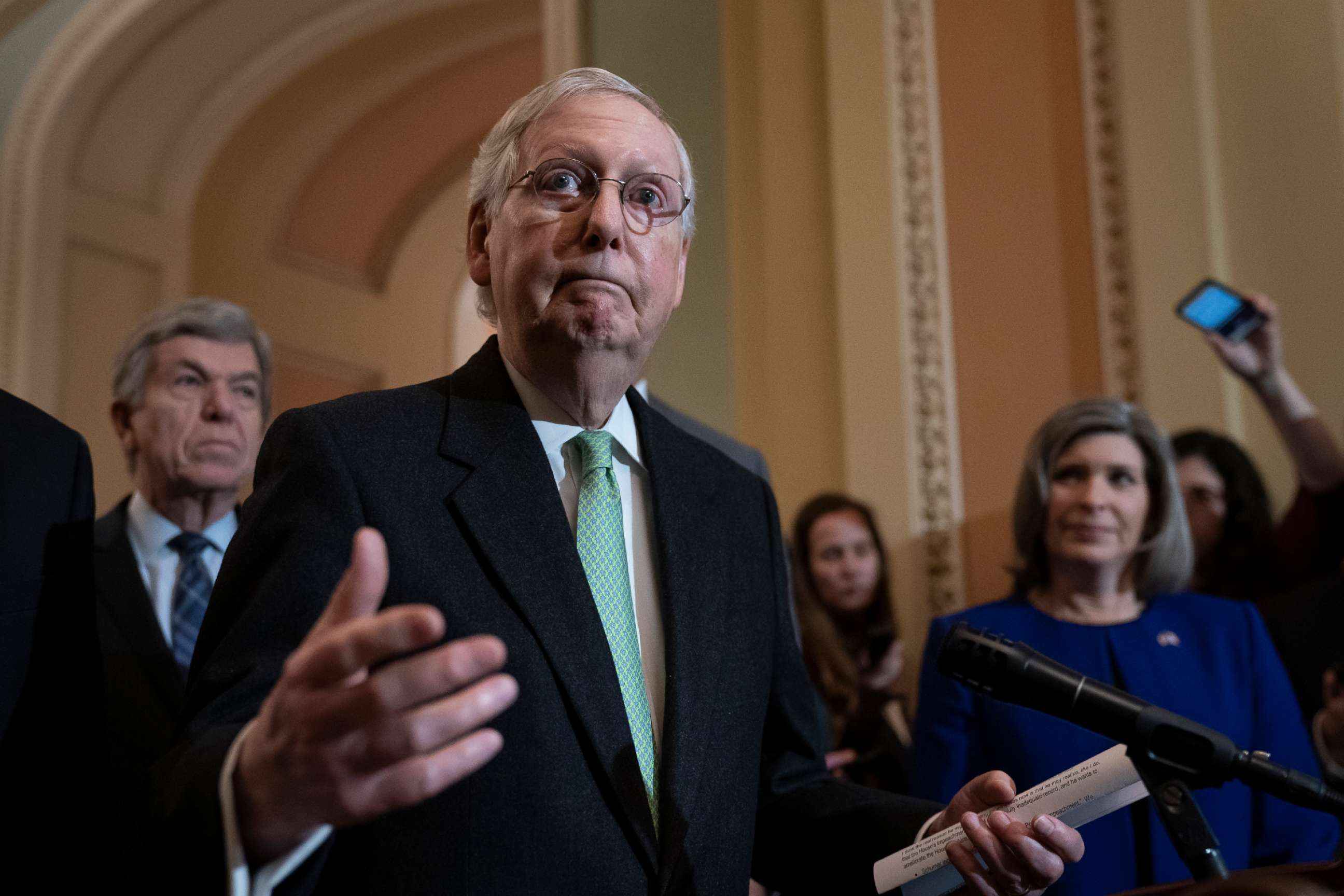 PHOTO: Senate Majority Leader Mitch McConnell, center, dismisses the impeachment process against President Donald Trump as he meets with reporters at the Capitol in Washington, Dec. 17, 2019.