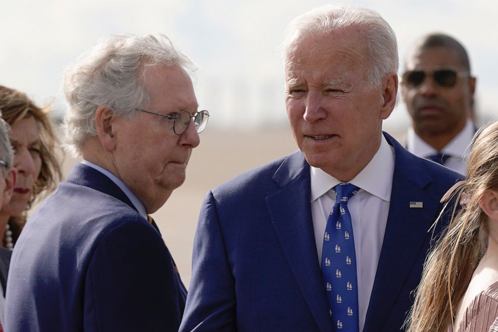 PHOTO: Mitch McConnell looks to President Joe Biden after Biden arrived at Cincinnati/Northern Kentucky International Airport in Hebron, Ky., Jan. 4, 2023.