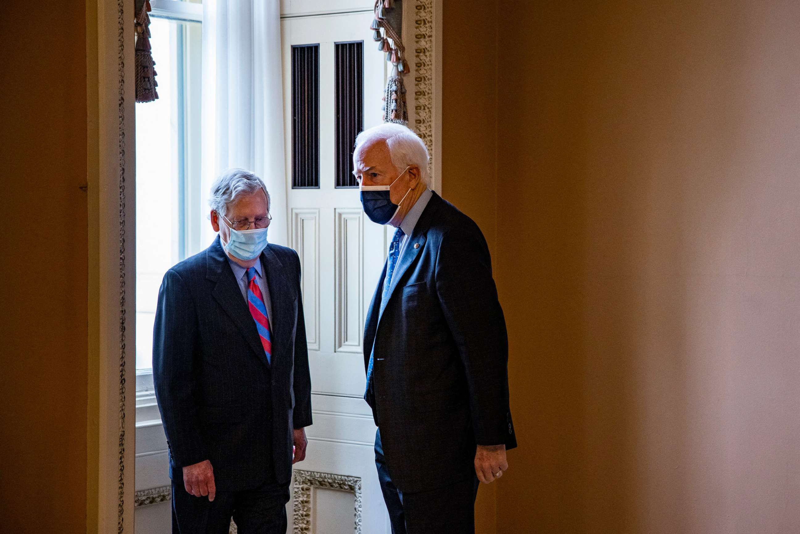 PHOTO: Senate Minority Leader Mitch McConnell talks to Senator John Cornyn in a hallway on Capitol Hill in Washington, D.C., April 29, 2021.