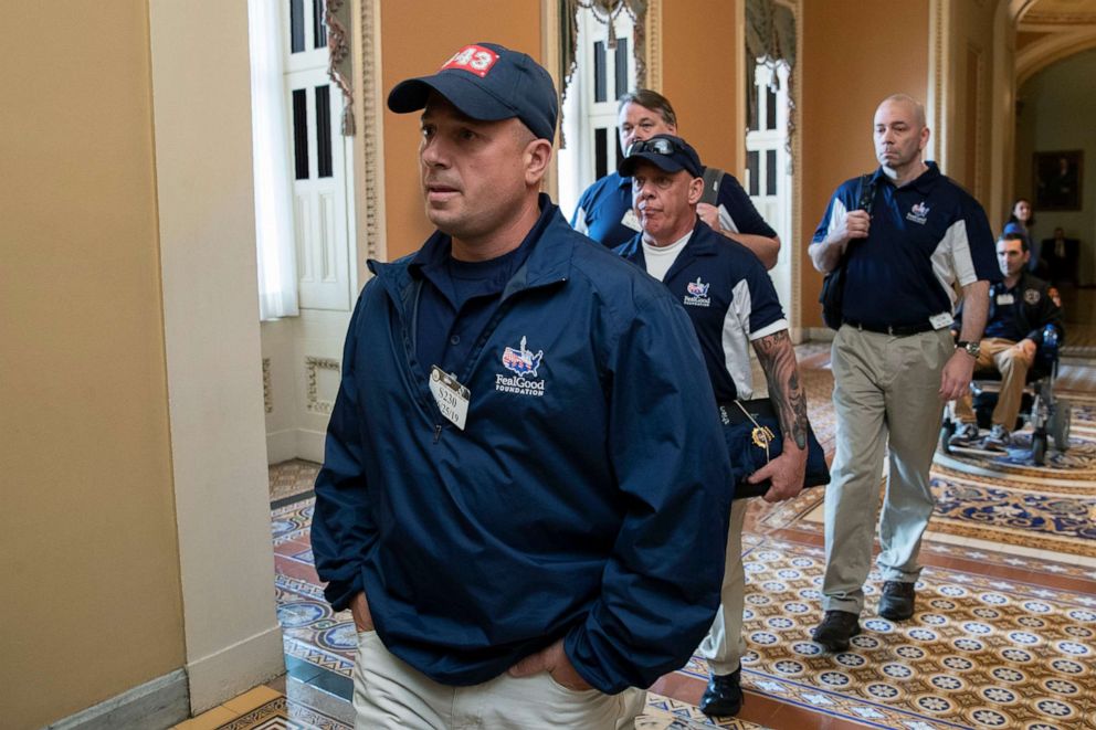 PHOTO: Sept. 11 first responders Ret. Lt. Michael O'Connell, from left, John Feal and other first responders walk to the office of Senate Majority Leader Mitch McConnell, for a meeting at McConnell's office on Capitol Hill in Washington, June 25, 2019.