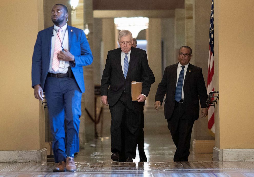 PHOTO: Senate Majority Leader Mitch McConnell walks from his office to the Senate floor at the  Capitol on March 18, 2020 in Washington, D.C.