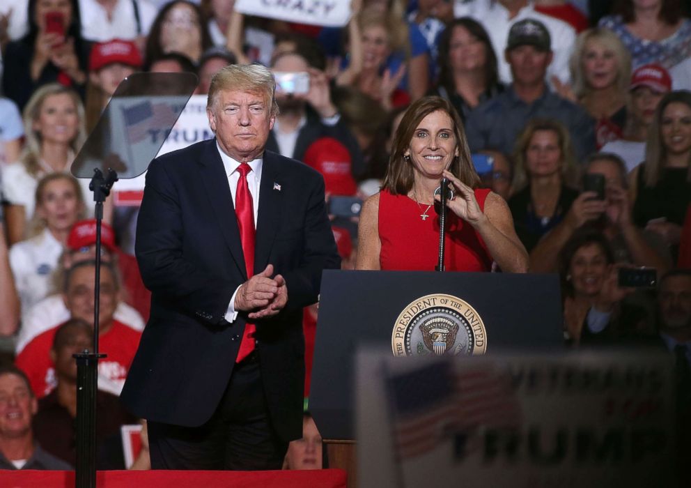 PHOTO: President Donald Trump welcomes Rep. Martha McSally, R-Ariz, to the stage during a rally at the International Air Response facility, Oct. 19, 2018, in Mesa, Ariz.