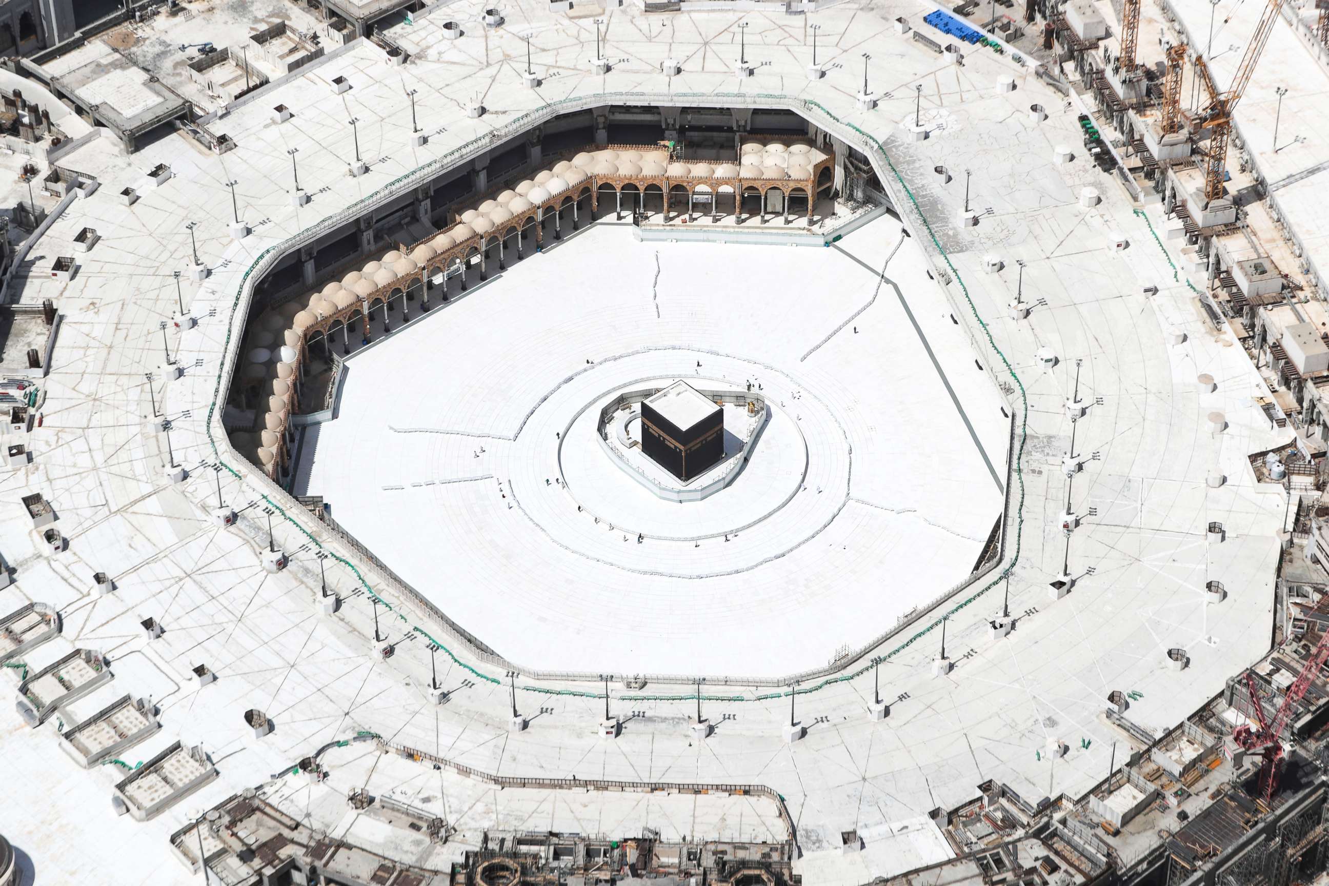 PHOTO: A few workers are seen nearby empty Kaaba after the precautions against the novel coronavirus (COVID-19) are taken in Mecca, Saudi Arabia, April 7, 2020. 