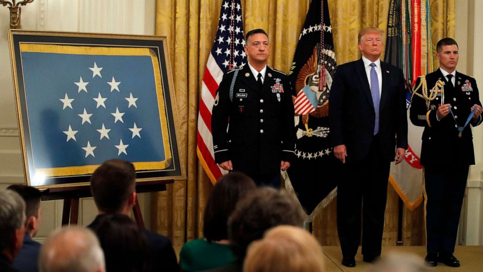 PHOTO: President Donald Trump stands with Army Staff Sgt. David Bellavia, left, as the citation is read before Bellavia was awarded the Medal of Honor at the White House on June 25, 2019.