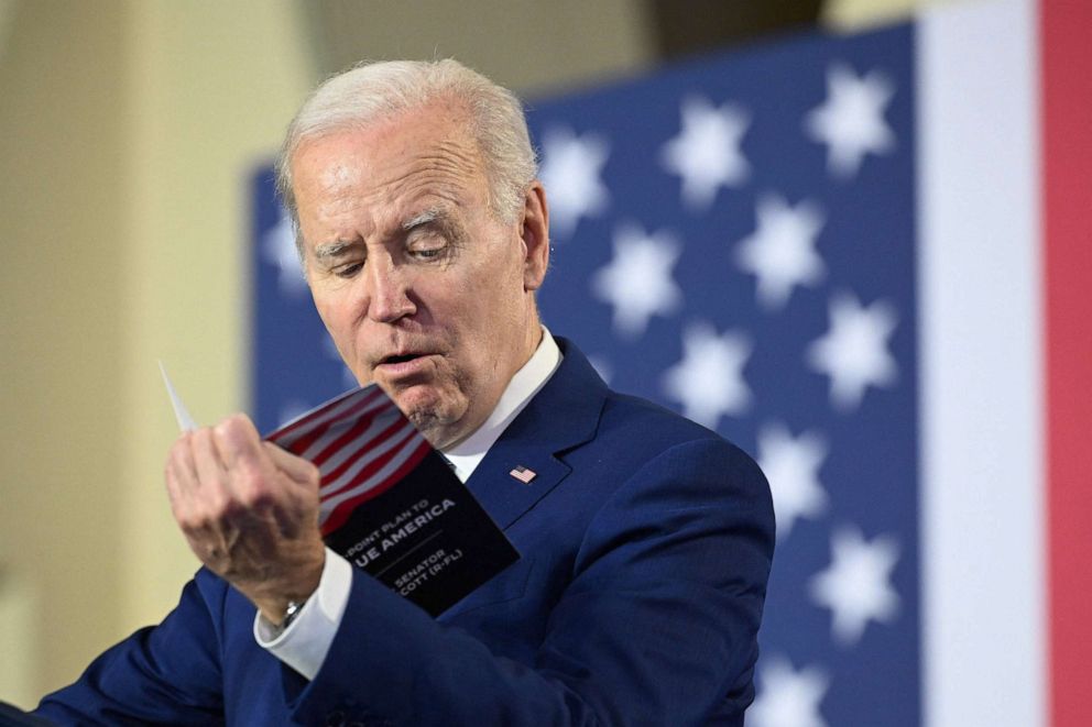 PHOTO: President Biden reads from a pamphlet by Sen. Rick Scott (R-FL), while delivering remarks on his plan to protect and strengthen Social Security and Medicare, as well as lower healthcare costs, at the University of Tampa in Fla., on Feb. 9, 2023.