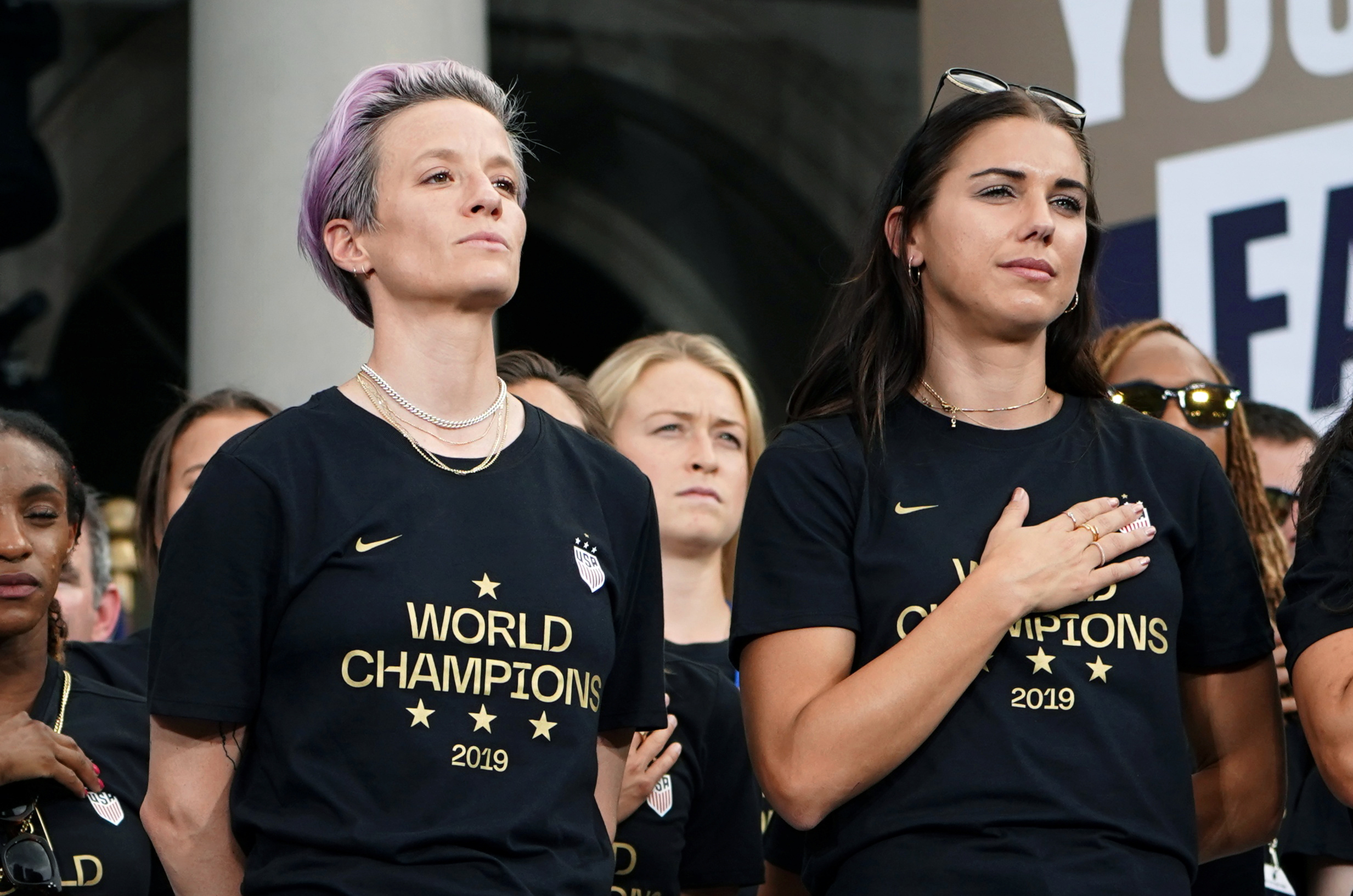 PHOTO: Megan Rapinoe and Alex Morgan of the U.S. stand during the national anthem at the Women's World Cup Champions Parade in New York City, July 10, 2019. 