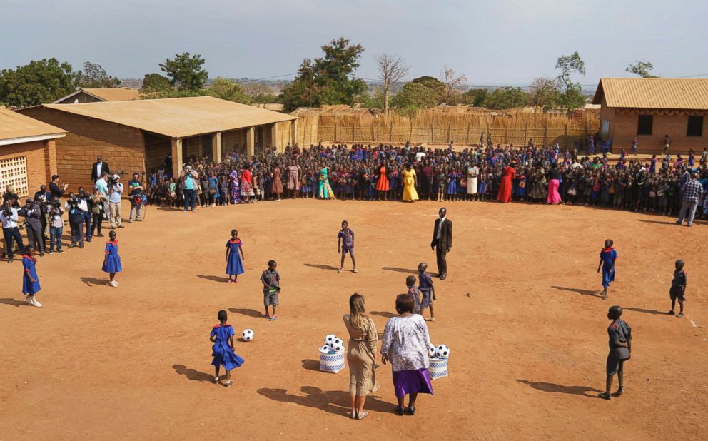 PHOTO: First lady Melania Trump and head teacher Maureen Masi watch children play with soccer balls at Chipala Primary School, in Lilongwe, Malawi, Oct. 4, 2018.