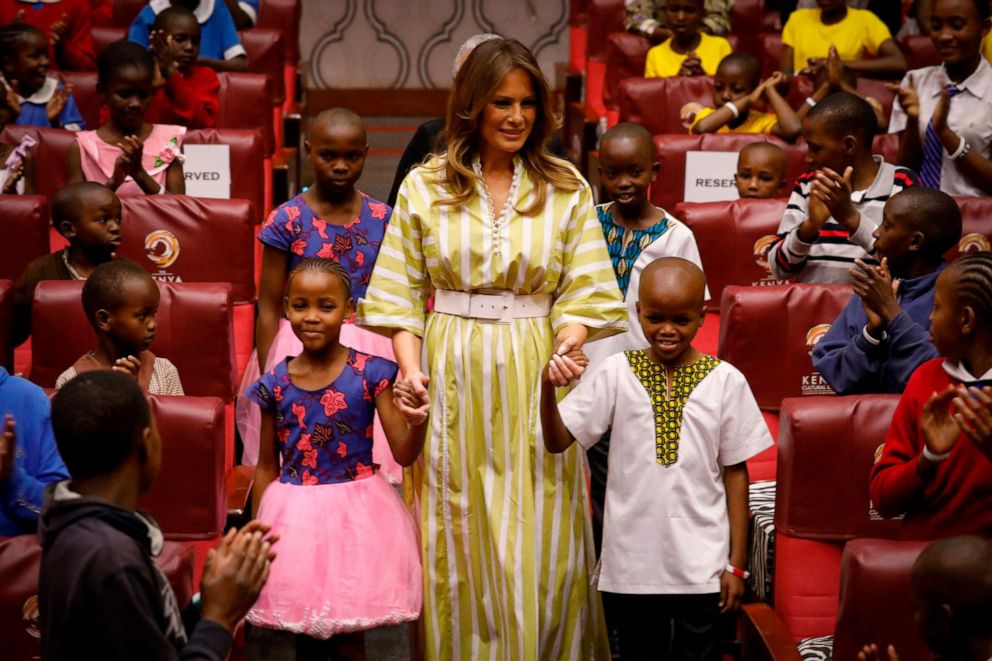 PHOTO: First lady Melania Trump smiles as she holds hands with Kenyan children upon her arrival at the Kenya National Theatre in Nairobi, Oct. 5, 2018.