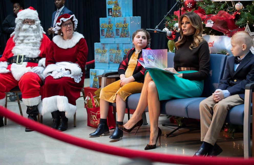 PHOTO: First lady Melania Trump reads the book, "Oliver the Ornament Meets Belle", alongside patients Sammie Burley and Declan McCahan, during a visit to Children's National Hospital in Washington, Dec. 6, 2019.
