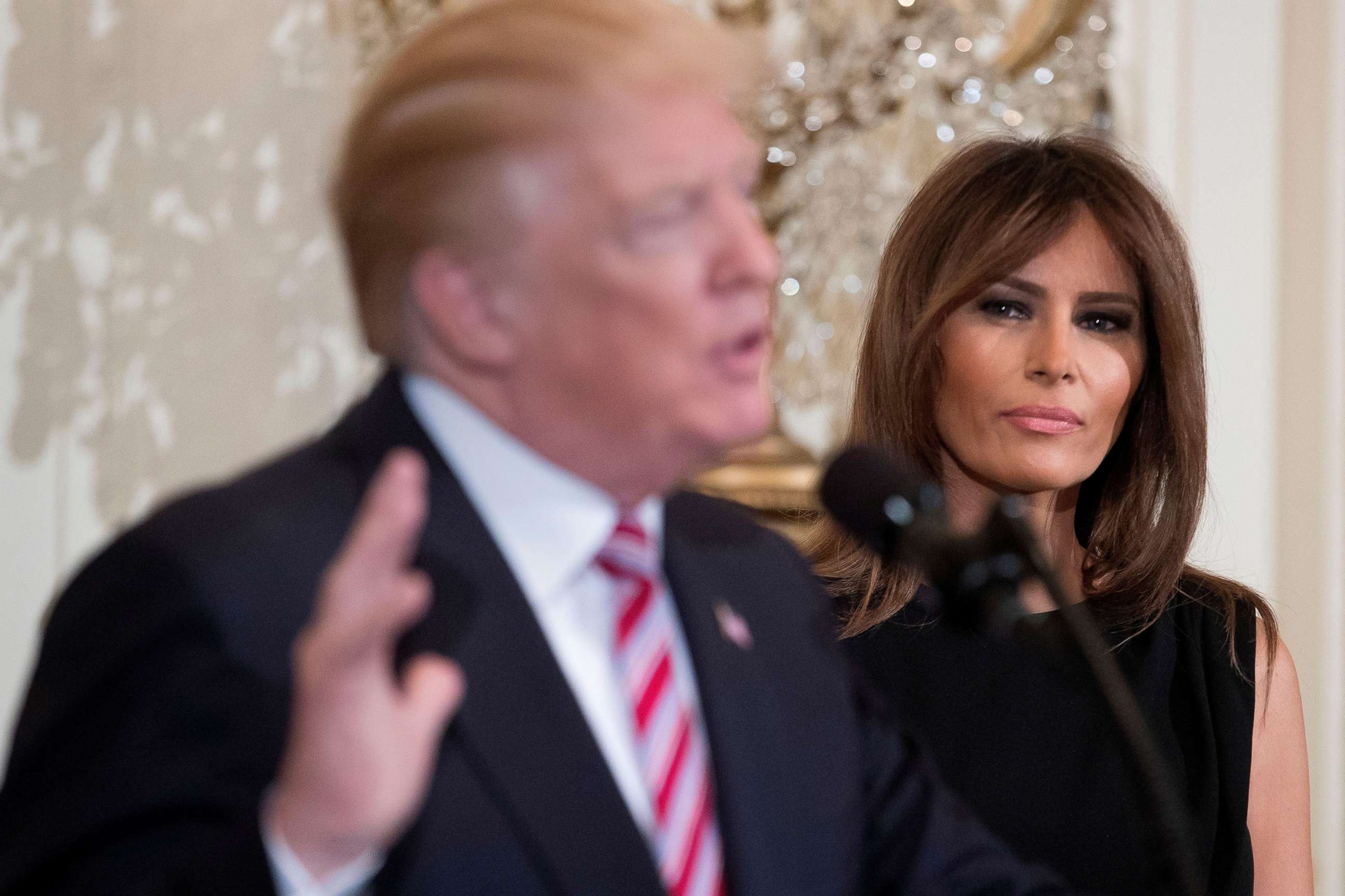 PHOTO: Melania Trump listens to President Donald J. Trump delivers remarks while hosting a reception in honor of National African American History Month, in the East Room of the White House, Feb. 13, 2018.