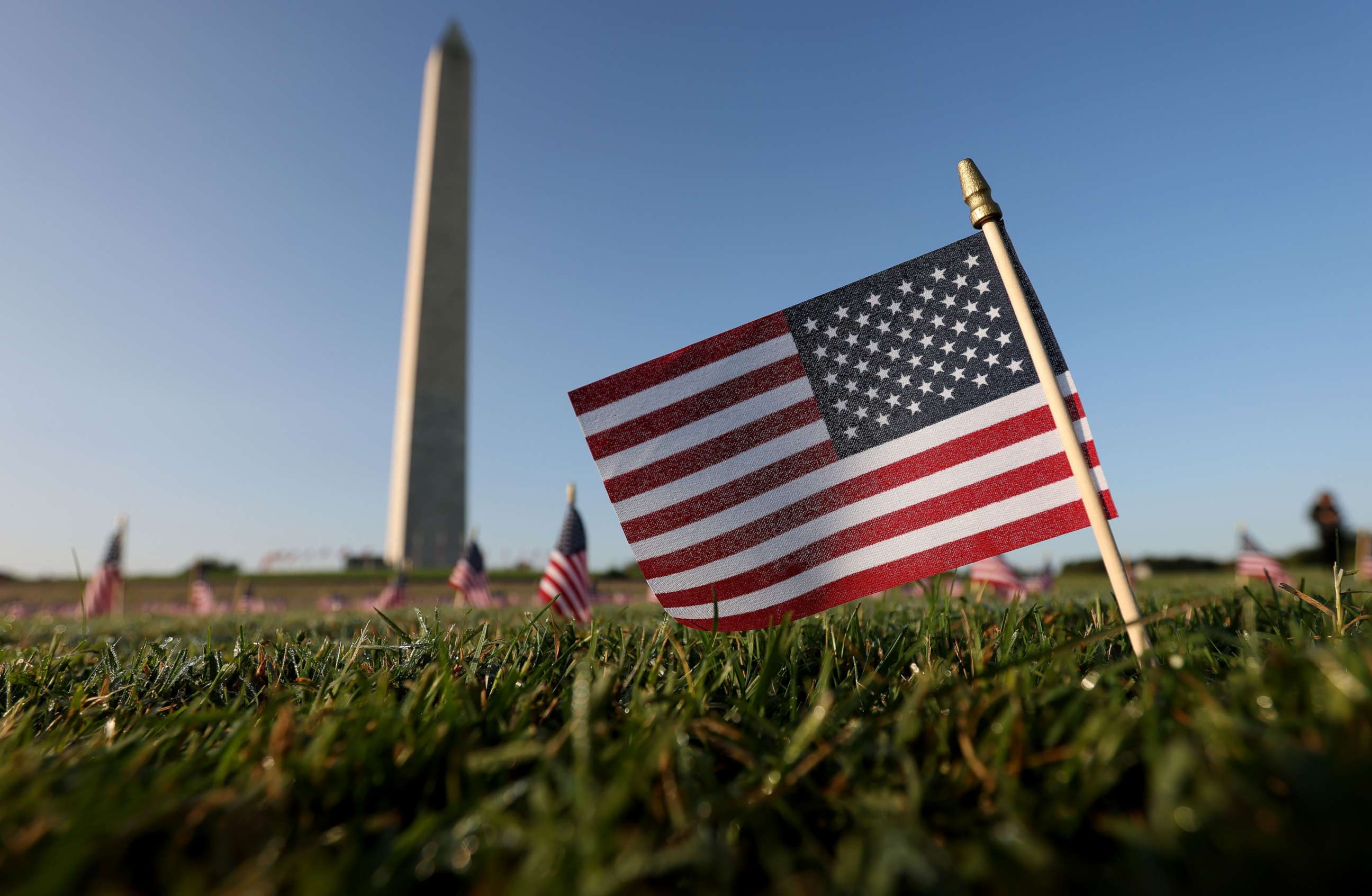 PHOTO: American flags at a COVID Memorial Project installation of 20,000 flags are shown on the National Mall as the United States crosses the 200,000 lives lost in the COVID-19 pandemic, Sept. 22, 2020, in Washington, DC.