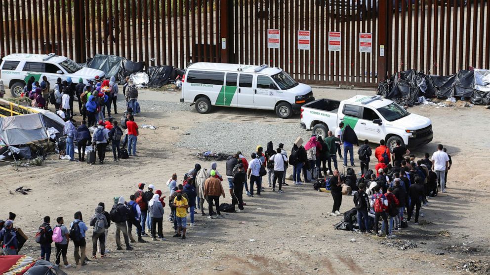 PHOTO: Migrants gather between the primary and secondary border fences in San Diego as the United States prepares to lift COVID-19-era restrictions known as Title 42 as seen from Tijuana, Mexico, May 8, 2023.