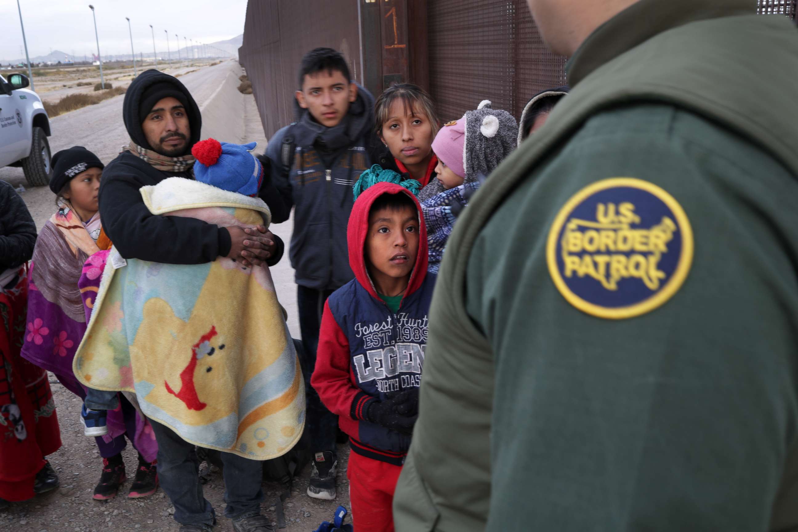 PHOTO: A U.S. Border Patrol agent speaks with Central American immigrants at the U.S.-Mexico border fence on Feb. 01, 2019, in El Paso, Texas.