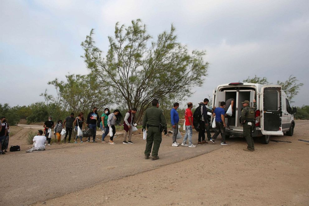 PHOTO: Migrants who had crossed the Rio Grande river into the United States are taken away by U.S. Border Patrol agents in Eagle Pass, Texas, on May 20, 2022.