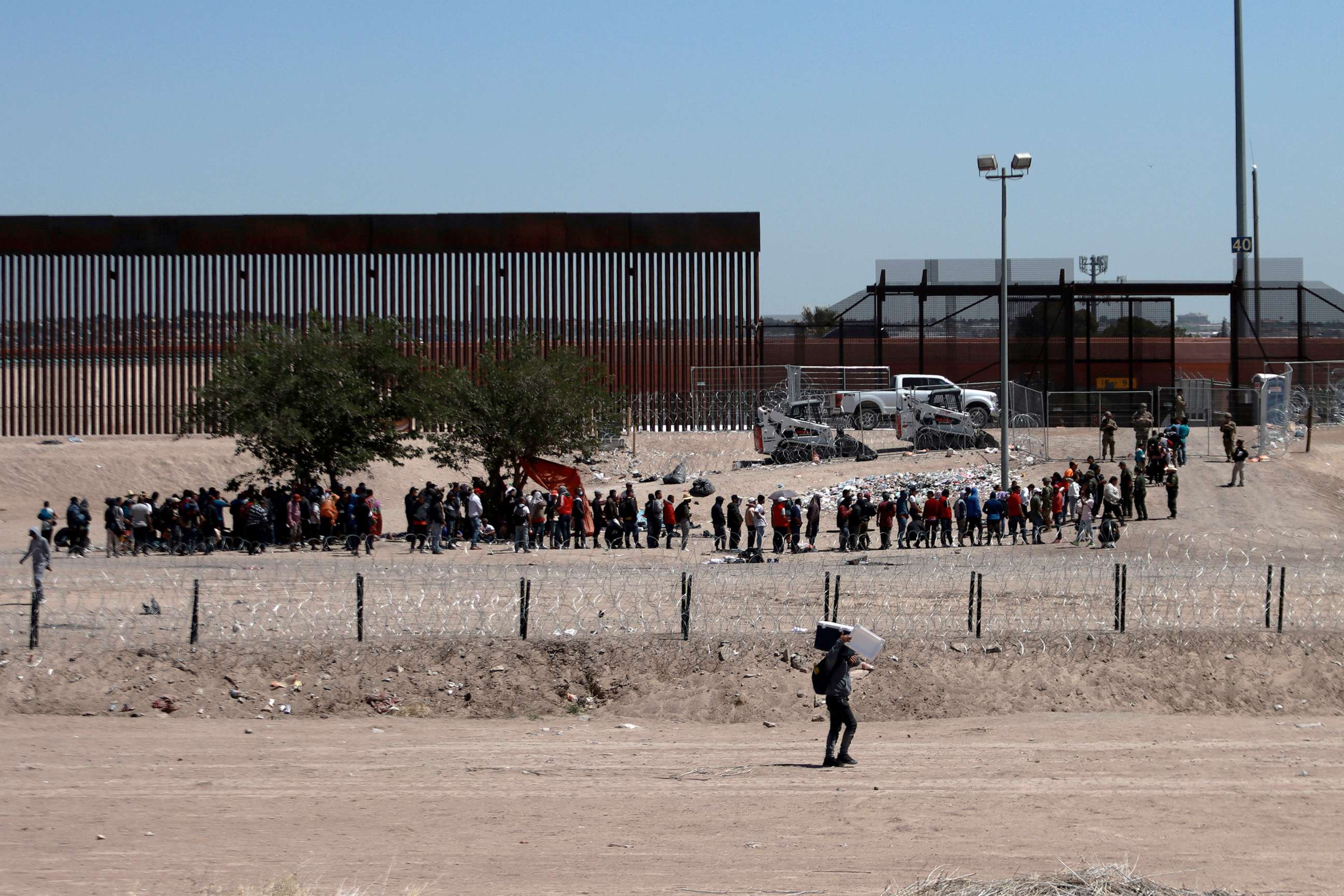 PHOTO: Migrants line up after being detained by US authorities at the US-Mexico border in Ciudad Juarez, Mexico, on April 30, 2023.