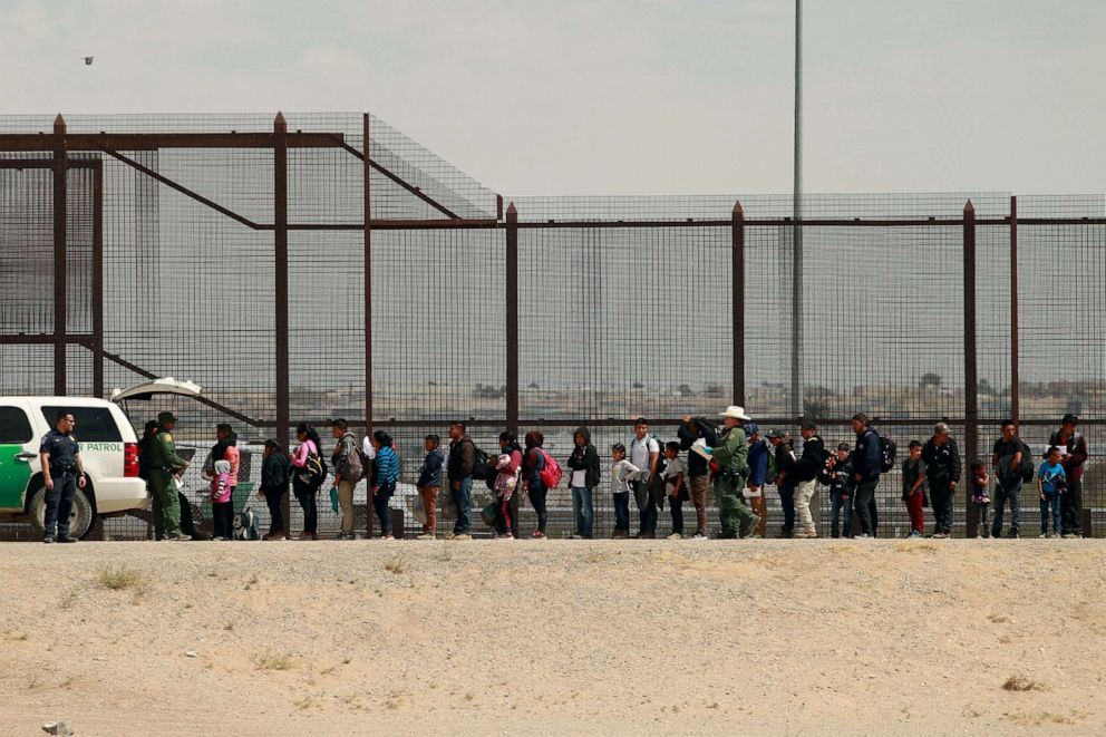 PHOTO:Migrants queue as they listen to U.S. Customs and Border Protection (CBP) officials after crossing illegally into the United States to request asylum, in El Paso, Texas, April 5, 2019. 