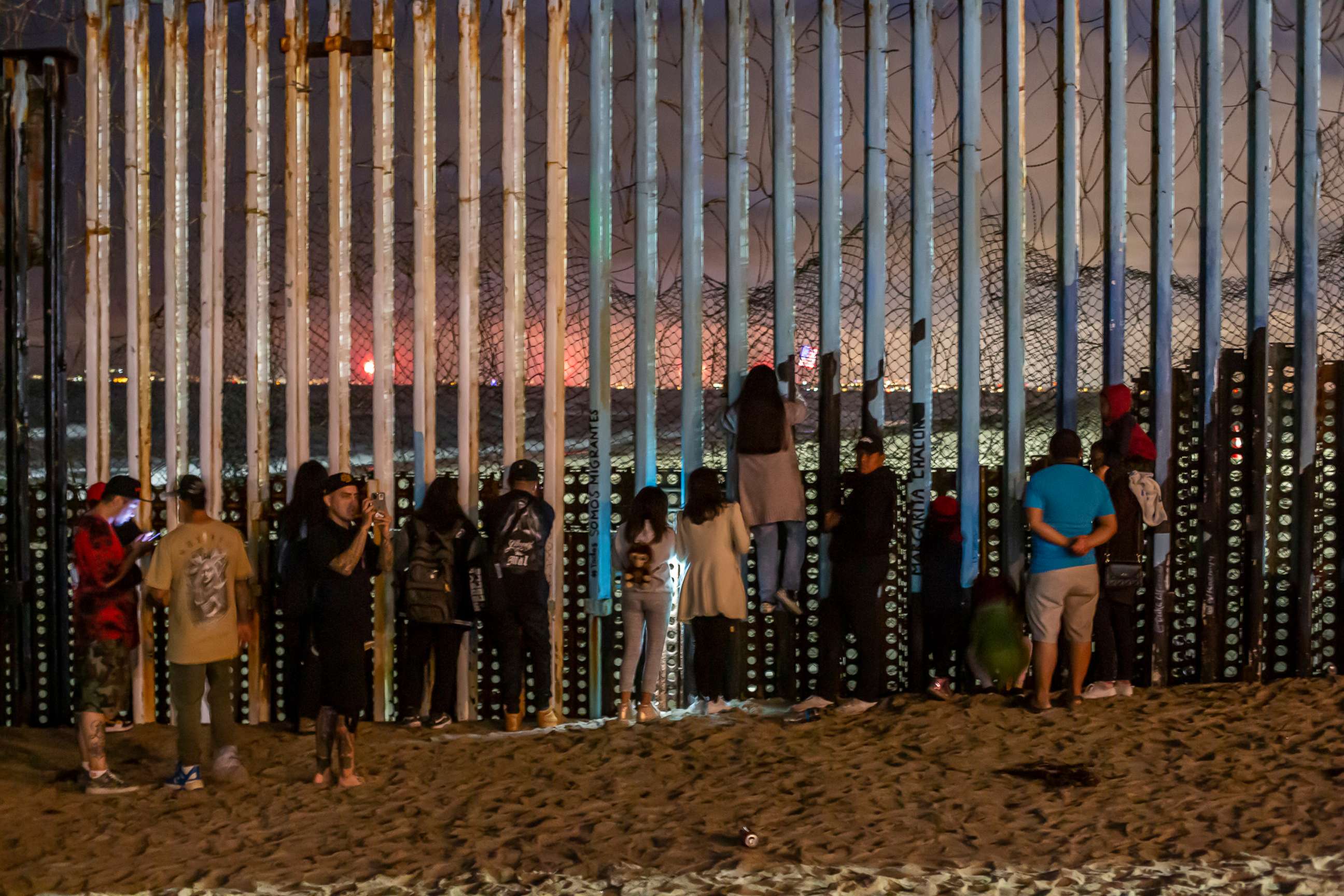 PHOTO: Hundreds of people watch from the border fence in Playas de Tijuana, Mexico, as U.S. Independence Day fireworks were launched several miles away in San Diego Bay, Calif., July 4, 2022.