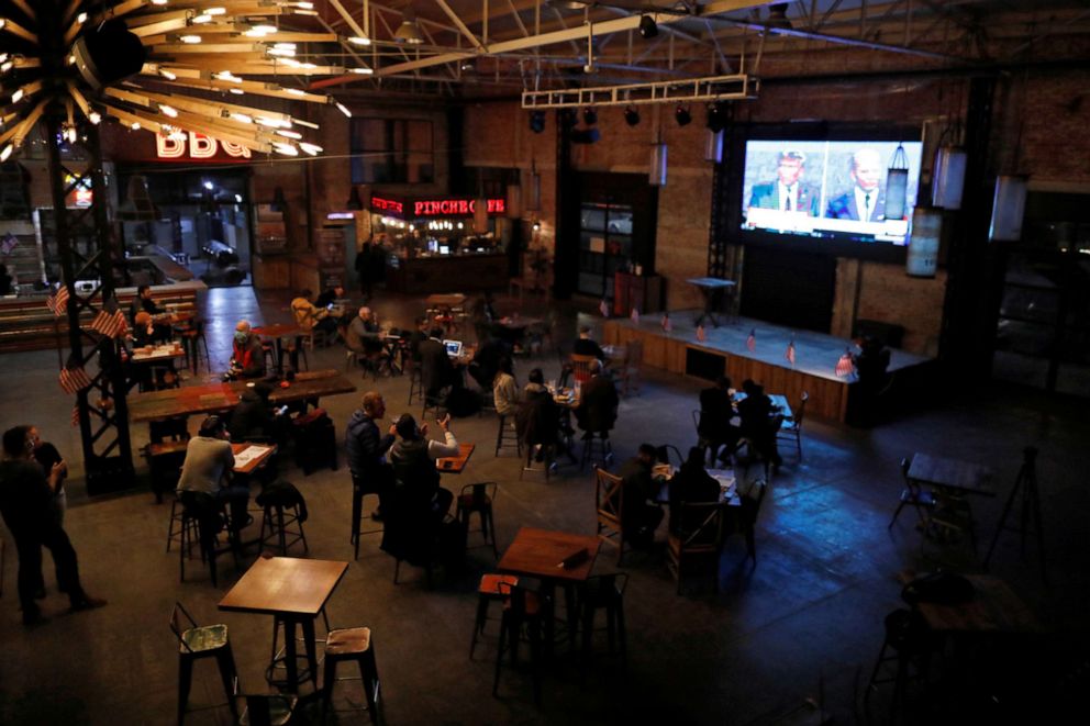 PHOTO: People watch the first 2020 presidential campaign debate between President Donald Trump and Democratic presidential nominee Joe Biden, at the Pinche Gringo restaurant in Mexico City, Mexico, Sept. 29, 2020.